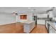 Open kitchen with center island flows into living area with decorative wood paneling at 6964 Lake Eaglebrooke Dr, Lakeland, FL 33813