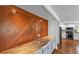 Kitchen featuring custom wood paneling, quartz countertops, and hardwood floors at 6964 Lake Eaglebrooke Dr, Lakeland, FL 33813