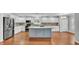 Bright kitchen with stainless steel appliances, custom backsplash, and large center island at 6964 Lake Eaglebrooke Dr, Lakeland, FL 33813