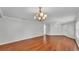 Spacious living area featuring hardwood floors, neutral walls, and an elegant chandelier at 6964 Lake Eaglebrooke Dr, Lakeland, FL 33813