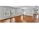 Open-concept living space with large windows, hardwood floors, and a modern chandelier at 6964 Lake Eaglebrooke Dr, Lakeland, FL 33813