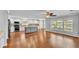 Open concept kitchen and living room area with hardwood floors at 6964 Lake Eaglebrooke Dr, Lakeland, FL 33813