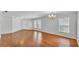 Expansive living room with hardwood floors, ample natural light, and a view of the front door at 6964 Lake Eaglebrooke Dr, Lakeland, FL 33813