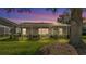 Covered, screened in back porch with a view of the landscaped backyard and manicured shrubs at 6964 Lake Eaglebrooke Dr, Lakeland, FL 33813