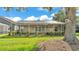 Covered, screened in back porch with a view of the landscaped backyard at 6964 Lake Eaglebrooke Dr, Lakeland, FL 33813