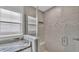 Tiled shower with glass door, window and marble countertop at 6964 Lake Eaglebrooke Dr, Lakeland, FL 33813