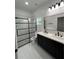 Modern bathroom featuring double vanity, walk-in glass shower, toilet, and white-tiled flooring at 801 Robson W St, Lakeland, FL 33805