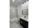 The full bathroom features a modern vanity, updated fixtures, and tile flooring at 801 Robson W St, Lakeland, FL 33805