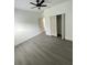 Bedroom with ceiling fan, wood-look floors, white walls, and closet with sliding doors at 801 Robson W St, Lakeland, FL 33805