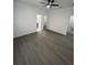 Spacious bedroom with ceiling fan, wood-look floors, white walls, and multiple entry points at 801 Robson W St, Lakeland, FL 33805