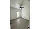 This bedroom features gray wood flooring, white walls, and a ceiling fan at 801 Robson W St, Lakeland, FL 33805