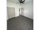 Bedroom with gray wood flooring and a closet for storage at 801 Robson W St, Lakeland, FL 33805