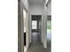 Hallway with gray wood flooring showcasing doorways to various rooms in the home at 801 Robson W St, Lakeland, FL 33805