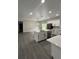 Beautiful kitchen island with white cabinetry and modern fixtures overlooks the living area at 801 Robson W St, Lakeland, FL 33805