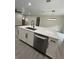 Close-up of kitchen island, showcasing quartz countertop, stainless steel dishwasher, and modern fixtures at 801 Robson W St, Lakeland, FL 33805