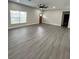 The light and bright living room boasts sleek floors, a large window, and an open layout at 801 Robson W St, Lakeland, FL 33805