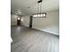 Bright living room featuring gray floors, recessed lighting, and a decorative chandelier at 801 Robson W St, Lakeland, FL 33805