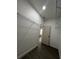 Walk-in closet with wood-look floors, white walls, wire shelving, and natural light at 801 Robson W St, Lakeland, FL 33805