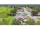 Aerial view showcasing a neighborhood with tree-lined streets, homes, and green spaces nearby at 849 Rockingham Rd, Lakeland, FL 33809