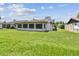 Beautiful backyard with a large, grassy area and views of the home's screened-in porch at 849 Rockingham Rd, Lakeland, FL 33809