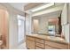 Bright bathroom featuring double sinks, a large mirror, and a walk-in shower at 849 Rockingham Rd, Lakeland, FL 33809