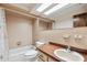 Bathroom featuring a skylight, neutral tile, and a vanity sink at 849 Rockingham Rd, Lakeland, FL 33809
