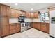 Well-lit kitchen featuring wooden cabinets, granite counters and stainless steel appliances at 849 Rockingham Rd, Lakeland, FL 33809