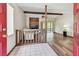 Inviting living room featuring a fireplace, wood floors, ceiling fan, and access to the sunroom at 849 Rockingham Rd, Lakeland, FL 33809