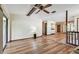 Spacious open living room featuring wood floors, a ceiling fan, a wet bar, and lots of natural light at 849 Rockingham Rd, Lakeland, FL 33809