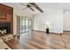 Bright living room with a ceiling fan, wood-look floors, fireplace and sliding glass doors to sunroom at 849 Rockingham Rd, Lakeland, FL 33809
