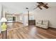 Open-concept living room with ceiling fan, wood floors, and ample lighting at 849 Rockingham Rd, Lakeland, FL 33809