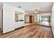 Open-concept living room with wood floors, ceiling fan, wet bar, and mirrored wall for spacious and airy feel at 849 Rockingham Rd, Lakeland, FL 33809