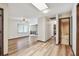 Open-plan living room with updated floors, ceiling fan and access to the bathroom at 849 Rockingham Rd, Lakeland, FL 33809