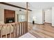Inviting living room featuring a fireplace, wood floors, ceiling fan, and access to the sunroom at 849 Rockingham Rd, Lakeland, FL 33809