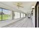 Sunroom featuring bright tile flooring, a ceiling fan, and large windows to the backyard at 849 Rockingham Rd, Lakeland, FL 33809