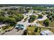 Overhead shot of a gated community entrance with a central fountain, surrounded by lush greenery and well-maintained roads at 9017 Se 119Th St, Summerfield, FL 34491