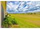 Spacious backyard with a well-maintained lawn and views of the community at 9017 Se 119Th St, Summerfield, FL 34491