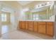 Bathroom featuring double vanity and an entry to the main bedroom at 9017 Se 119Th St, Summerfield, FL 34491