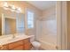 Bright bathroom features a vanity, toilet, and tub with shower at 9017 Se 119Th St, Summerfield, FL 34491