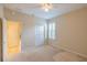 Bright bedroom with beige walls, carpet, ceiling fan, closet and window with shutters at 9017 Se 119Th St, Summerfield, FL 34491