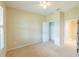 Bright bedroom features beige walls, carpet, ceiling fan, closet and a window with shutters at 9017 Se 119Th St, Summerfield, FL 34491