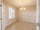 Bright dining room with wood-look floors, large window, and a chandelier at 9017 Se 119Th St, Summerfield, FL 34491