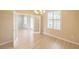 Elegant dining room with wood-look floors, a chandelier and French doors at 9017 Se 119Th St, Summerfield, FL 34491