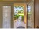 View from the open front door showing the well-maintained front yard and neighborhood at 9017 Se 119Th St, Summerfield, FL 34491