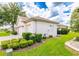 Exterior elevation features well-manicured lawn and mature shrubbery surrounding the home at 9017 Se 119Th St, Summerfield, FL 34491