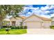 Charming single-story home with a well-manicured lawn, three-car garage, and a neatly landscaped front yard at 9017 Se 119Th St, Summerfield, FL 34491