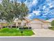 Charming single-Gathering home with a three-car garage, mature landscaping, and a welcoming front entrance at 9017 Se 119Th St, Summerfield, FL 34491