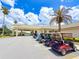 Row of golf carts parked at the community clubhouse entrance, showcasing convenient amenities at 9017 Se 119Th St, Summerfield, FL 34491