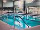 Bright and inviting indoor swimming pool with multiple lanes for swimming laps and staying active year-round at 9017 Se 119Th St, Summerfield, FL 34491