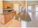 Kitchen with breakfast bar, ample cabinet space, and modern appliances that opens to the living area at 9017 Se 119Th St, Summerfield, FL 34491